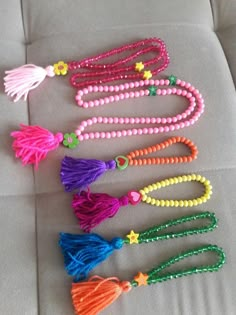 colorful beads and tassels are laid out on a couch