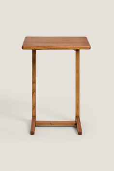 a small wooden table sitting on top of a white floor