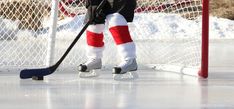 a hockey goalie is standing on the ice