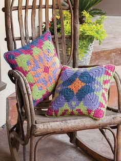 a rocking chair with two colorful pillows on it's back and the words tapestry pillows written in large letters