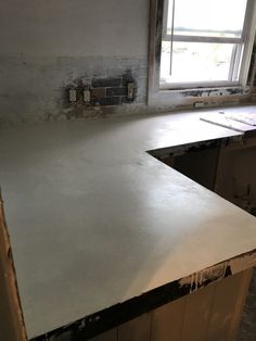 an unfinished kitchen counter in the process of being painted