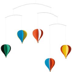 three hot air balloons hanging from strings on a white background with one balloon in the middle