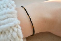 Tiny black spinel beaded gemstone bracelet with hematite gold | Etsy Baby Black Beads Bracelet, Nazariya Bracelet For Baby, Hand Mangalsutra Bracelet In Gold, Mangalsutra Bracelet Design, Black Beads Bracelet Gold, Hand Mangalsutra Bracelet, Nazariya Bracelet, Bracelet With Black Beads, Black Beads Bracelet