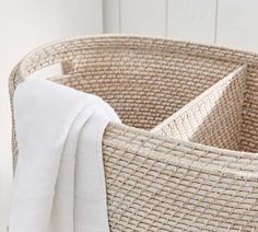 a white towel is in a woven basket