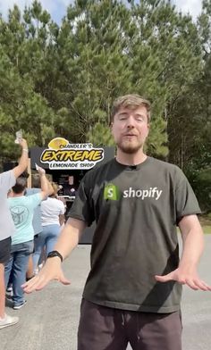 a man standing in the middle of a parking lot holding his hands out to someone