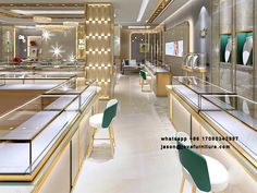 the interior of a luxury jewelry store with gold and white walls, green chairs and counter tops