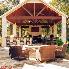 an outdoor covered patio with chairs and tables