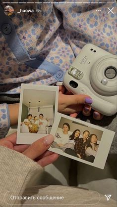 a person holding two polaroid pictures in their hands