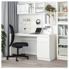 a white desk and chair in front of a book shelf with books on top of it