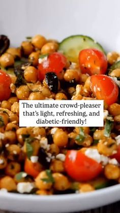 a white bowl filled with chickpeas, tomatoes, cucumbers and feta cheese