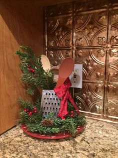 a kitchen counter topped with a red plate covered in christmas decorations