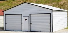 two garages side by side with grass on the roof and one door open in front