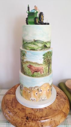 three tiered cake with farm animals painted on it