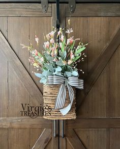 a basket with flowers hanging on the side of a wooden door that says virginia treasures