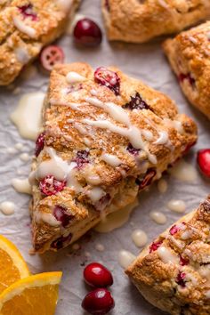 cranberry orange scones with white glaze and fresh cranberries on the side