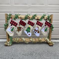 christmas stockings hanging from a wooden frame