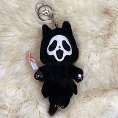 a stuffed animal keychain with a small toothbrush in it's mouth