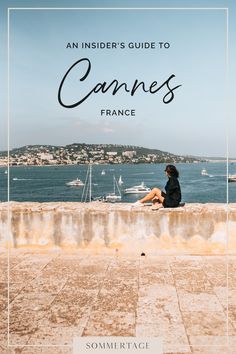 a woman sitting on top of a stone wall next to the ocean with text overlay that reads an insider's guide to cannes france