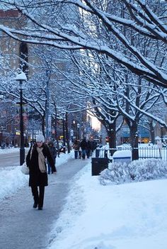 a person walking down a snow covered sidewalk