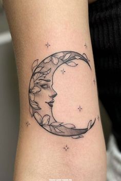 a woman's arm with a tattoo on it that shows the moon and stars