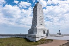 there is a monument in the middle of a field with stairs leading up to it