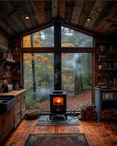 a wood burning stove sitting inside of a living room next to a large glass window