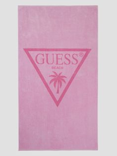 a pink towel with the words guess on it and a palm tree in the middle