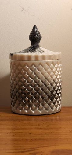 a white and black container sitting on top of a wooden table