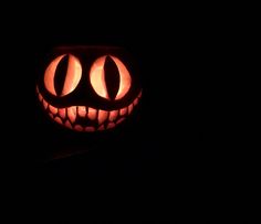 a carved pumpkin with two eyes in the dark