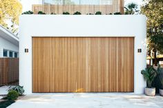 a white house with a wooden garage door