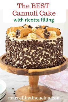 the best cannoli cake with ricotta filling is on a wooden platter