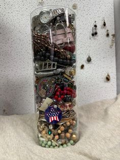 a glass vase filled with lots of assorted items