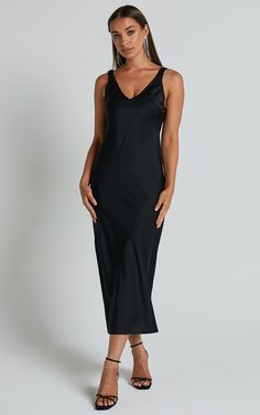 Turn heads and make a statement in our Agnia Midi Dress. This stunning black satin slip dress is the perfect choice for your next cocktail event or special occasion. The plunging neckline adds a touch of allure, while the elasticated back strap detail ensures a comfortable and secure fit all night long. Made from high-quality polyester, this sleeveless dress combines style with comfort, making it an essential addition to your wardrobe. Whether you're hitting the dance floor or sipping cocktails Satin V-neck Night Dress, Night V-neck Dress With Satin Finish, Satin Midi Dress With Spaghetti Straps For Night Out, Black Satin Spaghetti Strap Dress, Modal Satin V-neck Party Dress, Sleek Satin Dress For Dinner, Sleek Satin Dinner Dress, Fitted V-neck Slip Dress In Modal Satin, Modal Satin Fitted Slip Dress For Party