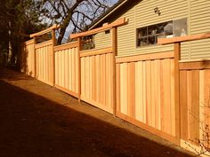 a wooden fence is next to a house