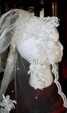 a mannequin with a veil and lace on it