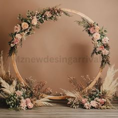 an arrangement of flowers and plants arranged in a circle on a wooden table with a brown background