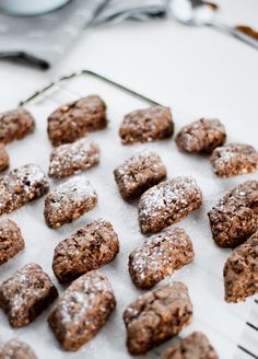 chocolate cookies and powdered sugar on a baking sheet