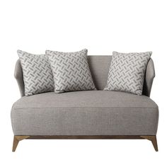 a gray couch with three pillows on it