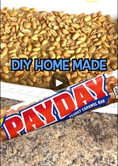 a candy bar with the words diy home made payday on it next to a pile of peanuts