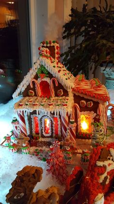 a gingerbread house decorated with candy canes and cookies