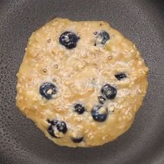 a pancake with blueberries on it and a spatula