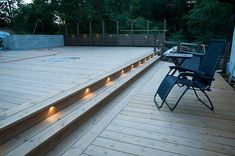 an outdoor deck with lights on it