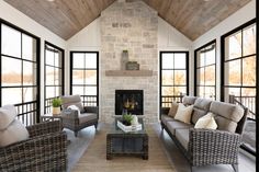 a living room filled with furniture and a fire place in the middle of an open floor plan