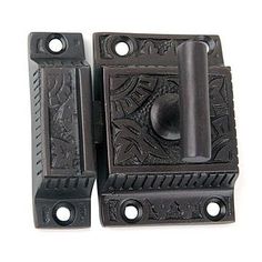 two black door handles with decorative designs on them