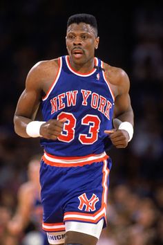 an image of a basketball player running on the court with his hand in his pocket