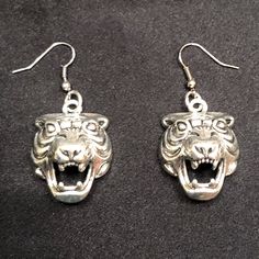 “In Any Jungle, What Is The Rarest Of Animalsthe Creature That Comes Along Only Once In A Generation?” “The White Tiger.” “That’s What You Are, In This Jungle.” - Antiqued Silver Metal Fierce Tiger Charms. - Charms Measure Approximately 1 X 1 Inch. - Silver Metal Fish Hook Style Earrings. - Clear Rubber Earring Backings Included Upon Request! Make A Statement With These Vicious, Fierce, Powerful, And Unique Tiger Earrings! Channel Your Inner Tiger King / Joe Exotic / Carole Baskin Cat Jungle, Carole Baskin, Fierce Tiger, Tiger Earrings, Joe Exotic, Metal Fish, Tiger King, Earrings Big, White Tiger