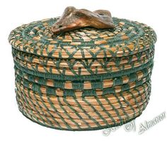 a close up of a basket with a frog on it's head in front of a white background