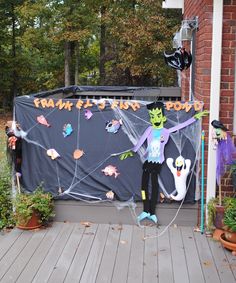 a halloween decoration on the front porch of a house with spider webs and spooky decorations