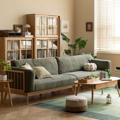 a living room filled with furniture and bookshelves on top of each other in front of a window