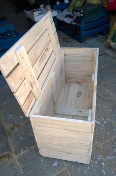 an empty wooden box sitting on the ground